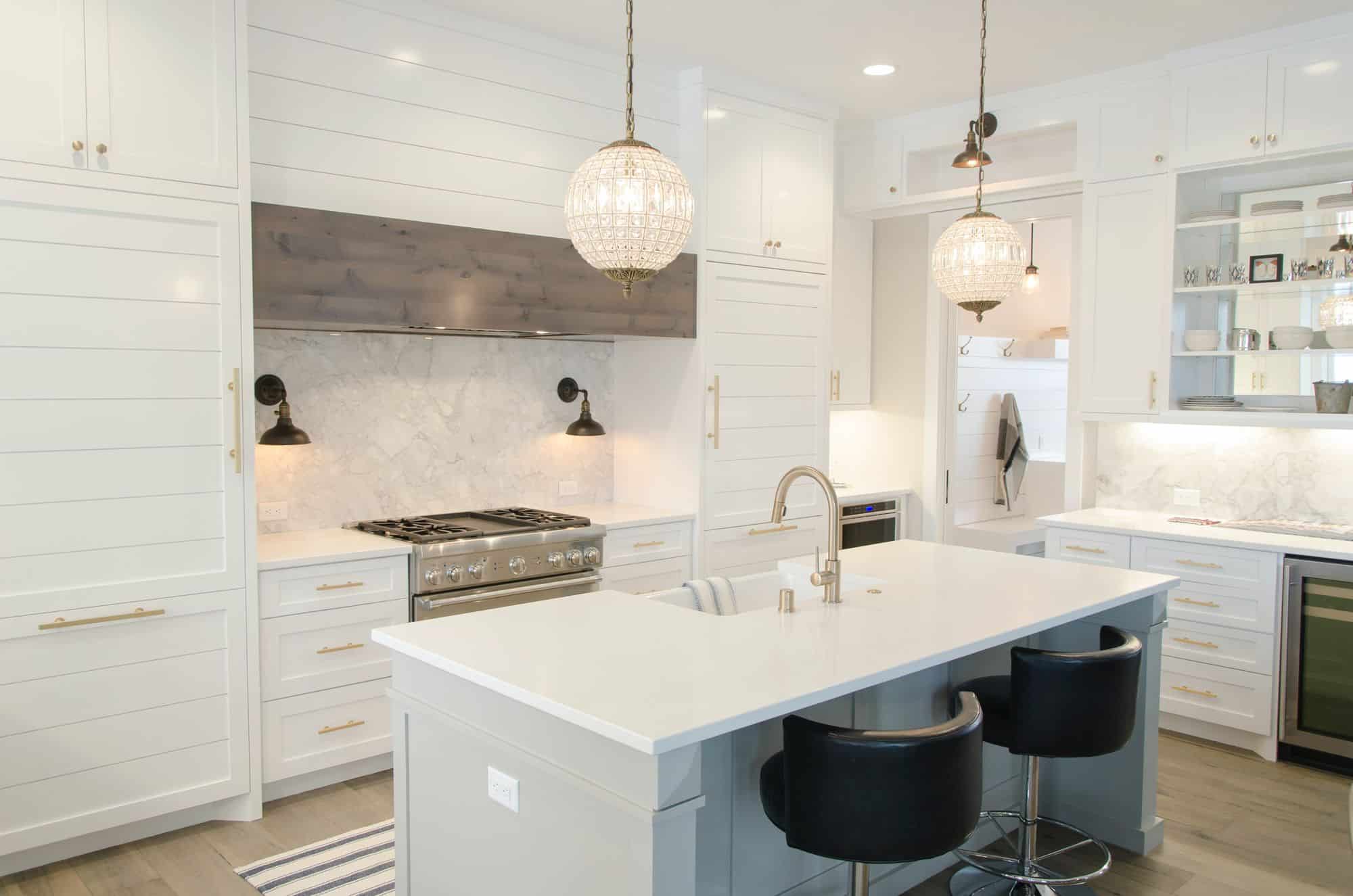 kitchen with white cupboards and an island with a sink.